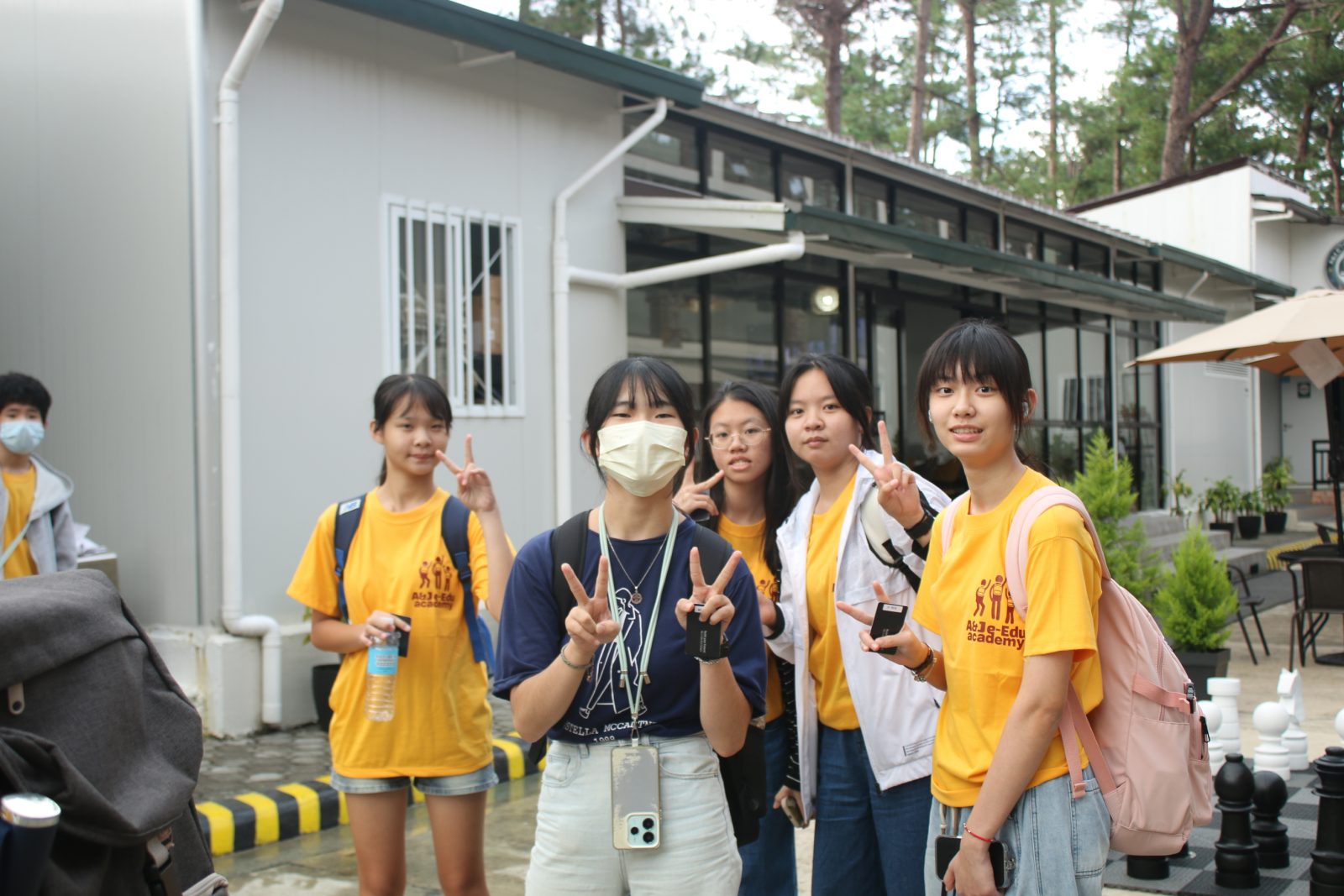 Young students smiling and speaking English together at a junior camp